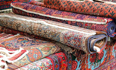 oriental rugs for sale in the market stall on the village street