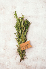 Bunch of Fresh Green Organic Rosemary Leaf on Grey Concrete Background Vertical