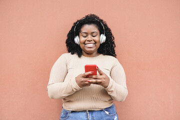 Young african woman enjoy music playlist with smartphone - Concept of technology and millennial generation
