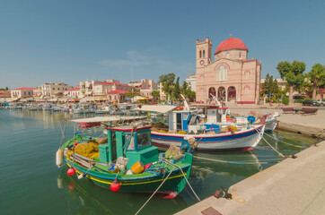 Fototapeta na wymiar Port of charming Aegina town with yachts and fishermen boats docked in Aegina island, Saronic gulf, Greece, in a sunny summer morning