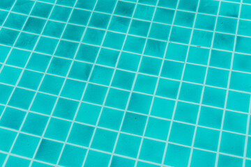 The blue texture of surface in the blue pool is clean, summer blue wave abstract or natural rippled water texture background, Swimming pool tile floor.