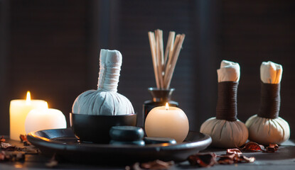 Spa background. Towel, candles, flowers, aroma sticks, massaging stones and herbal balls. Massage, oriental therapy, wellbeing and meditation.