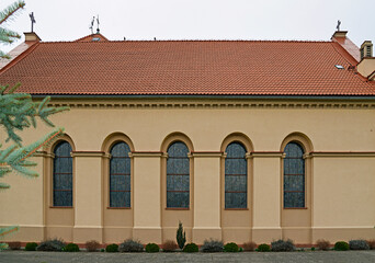 The belfry erected at the beginning of the 20th century and the close-up of the windows and the cross of the Catholic church of of Saint Anthony of Padua in the town of Gąski in Masuria in Poland © Jacek Sakowicz