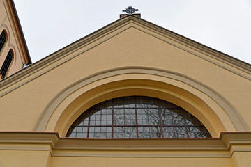 The belfry erected at the beginning of the 20th century and the close-up of the windows and the cross of the Catholic church of of Saint Anthony of Padua in the town of Gąski in Masuria in Poland © Jacek Sakowicz
