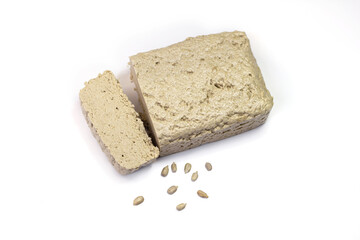 Halva close-up. Halva briquette isolated on white background. Sweet oriental dessert halva with sunflower seeds. Sweets for tea.