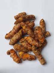 Group of turmeric roots isolated against white background. Turmeric or curcumin or curcuma longa is used for culinary and medicinal purposes.  Indonesian commonly used it for herbal drink or jamu.