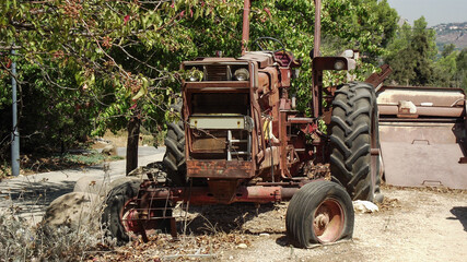 Fototapeta premium the old wheeled agricultural tractor of brown color is not serviceable