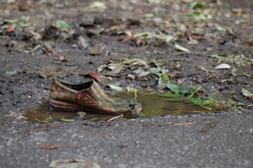 Naklejka na ściany i meble old shoe in puddle