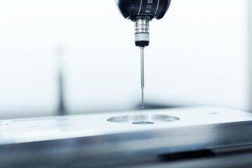 Operator inspection dimension metal parts by CMM after machining process in industrial