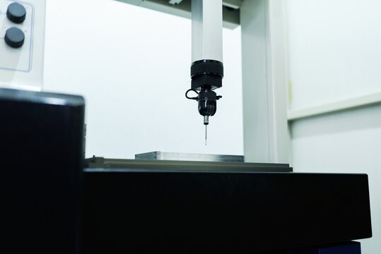 Operator inspection dimension metal parts by CMM after machining process in industrial