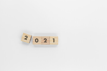 Square wooden blocks with text 2021 on top isolated on white background  Top view