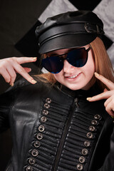 portrait of girl in sunglasses and leather cap