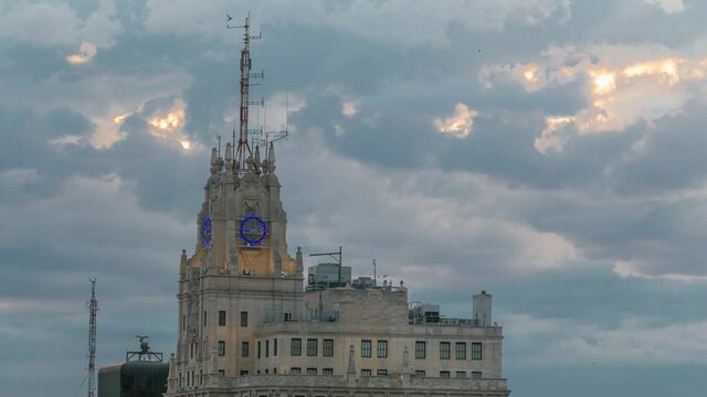 Telefonica Building is a Manhattan-style skyscraper at Gran Via timelapse with rays of sun at sunset time, Madrid, Spain. Telefonica Building is the tallest building in downtown Madrid rooftop aerial