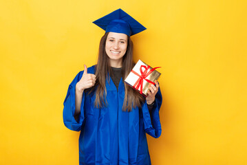 A young student is smiling at the camera because she received her gift for graduation