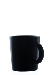 Single black Mug in vertical position, with the handle in an angle to the right, on white background with space for text