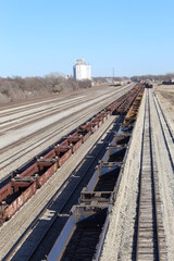 Fototapeta na wymiar Long line of empty ore cars on railroad tracks