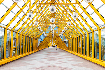 Pedestrian St. Andrew's Bridge with a yellow triangular interior