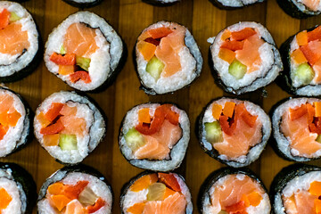 Homemade sushi. Traditional Japanese dish with rice, raw salmon and vegetables.