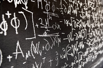 Mathematical formulas on dark black chalk board