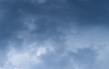 Dark blue clouds in the gloomy sky, soft focus.