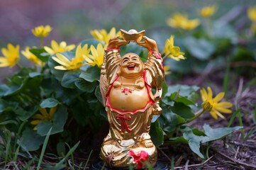 Buddha figure on a background of wildflowers.