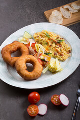 Donuts and egg served for breakfast on a table