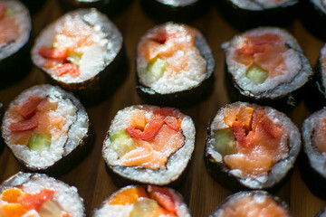Homemade sushi. Traditional Japanese dish with rice, raw salmon and vegetables.
