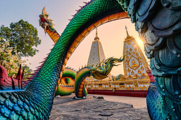 Rainbow carve serpent or colorful Thai Naga surrounding Sri Maha Pho Chedi stupa in the sunset at Wat Phra That Nong Bua - obrazy, fototapety, plakaty