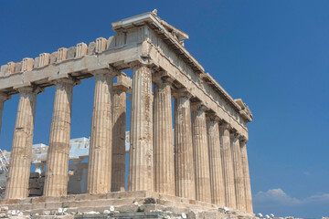 Fototapeta premium The ancient Parthenon temple on Acropolis hill, famous landmark and tourist attraction in Athens, Greece, in sunny summer day