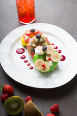 Three donuts served with fruits and berries