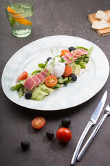 Fresh tuna salad served with poached egg on a plate