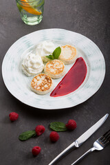 Fried cottage cheese fritters served on a plate