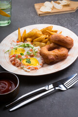 Donuts served with fried eggs and fried potatoes