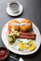 Berliner donuts served with sausage and fried eggs