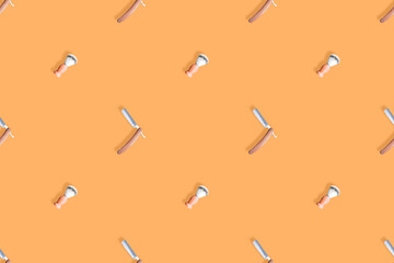 Seamless pattern on the theme of the barber shop. Straight razor and shaving brush background. 