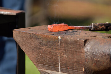 forging damascus steel by hand on the anvil 
