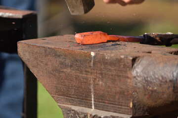 forging damascus steel by hand on the anvil 