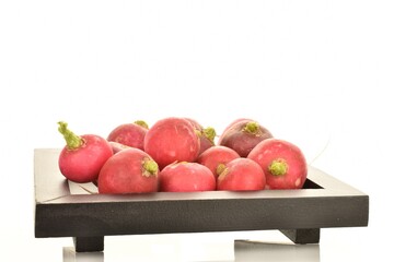 Fresh peeled ripe radish on a wooden tray, close-up, isolated on white.