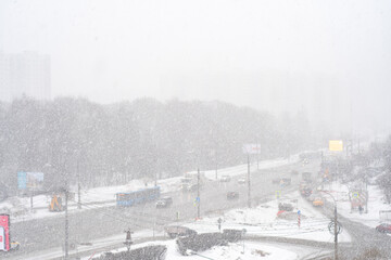 Heavy snowfall near the road. Winter landscape with snow near the freeway