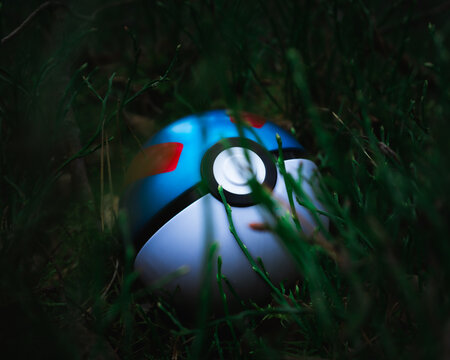 HAMBURG, GERMANY - Mar 20, 2021: Pokemon Super Ball in tall grass