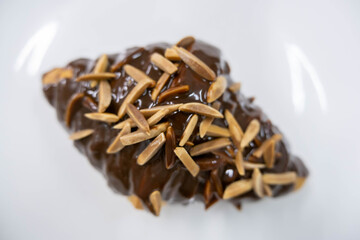  almond stick chocolate croissant on white plate
