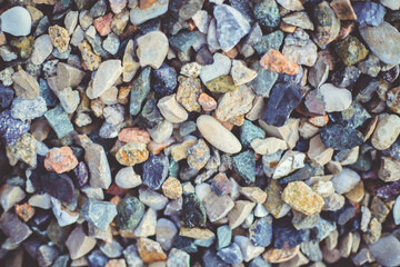 The background is made of stones of different sizes and colors. The texture of natural stones.