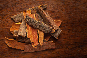 close-up of Organic cinnamon ( Cinnamomum Verum) or dalchini on wooden top background. Pile of Indian Aromatic Spice.