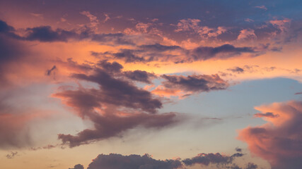 Fototapeta premium Panoramic view of dramatic clouds during sunset. The dynamic sky before a storm