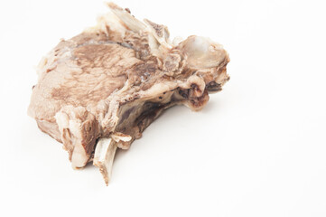 Piece of boiled beef with bone on white background