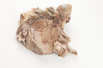 Piece of boiled beef with bone on white background