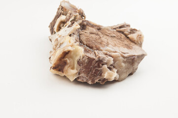 Piece of boiled beef with bone on white background