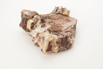 Piece of boiled beef with bone on white background