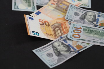 dollar and euro stand side by side, 50 euro and 100 dollar,