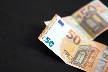 new and old 50 euro banknotes stand on black background,